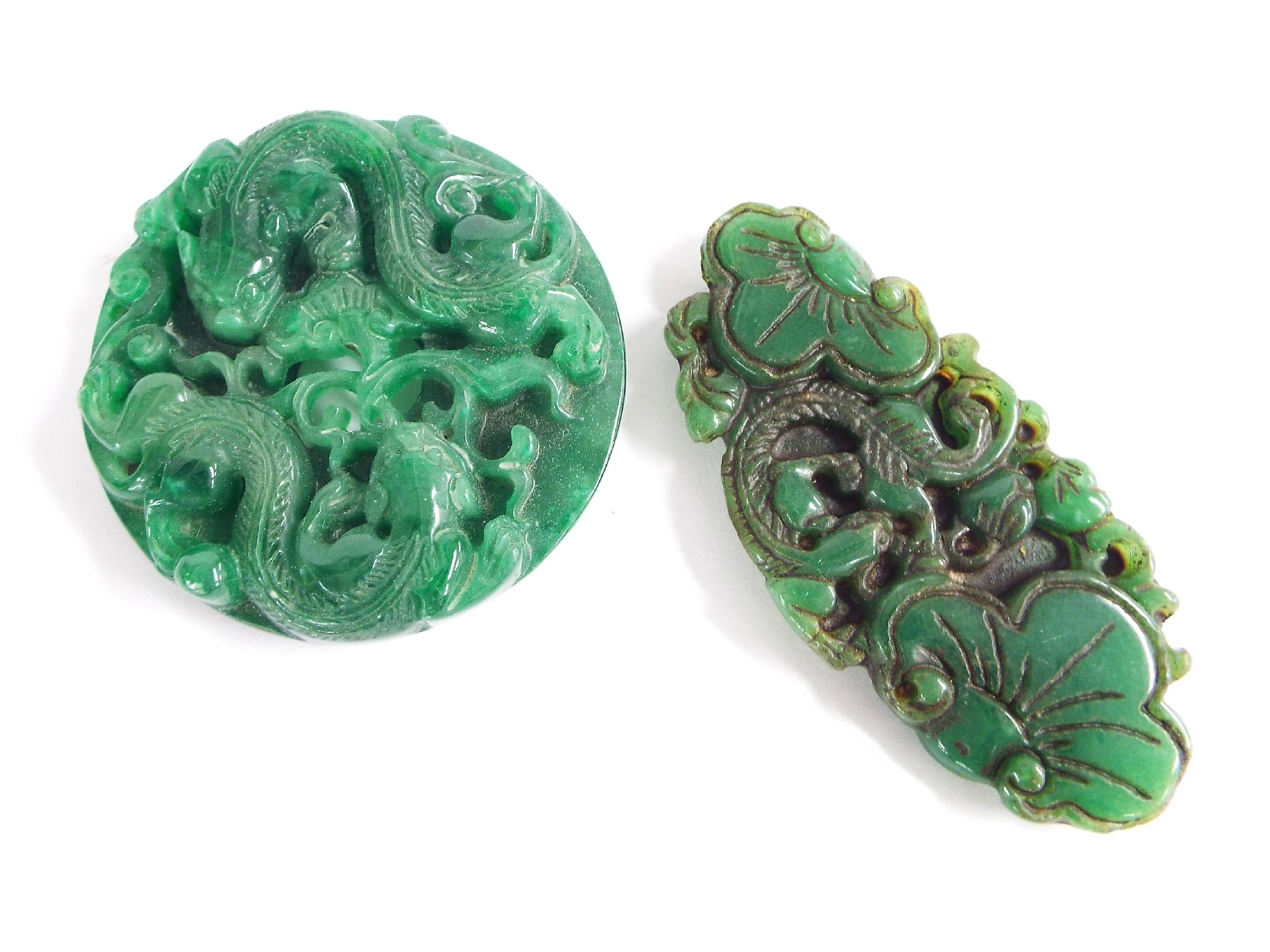 Appraisal: Two green hardstone pendants medallions possibly jade