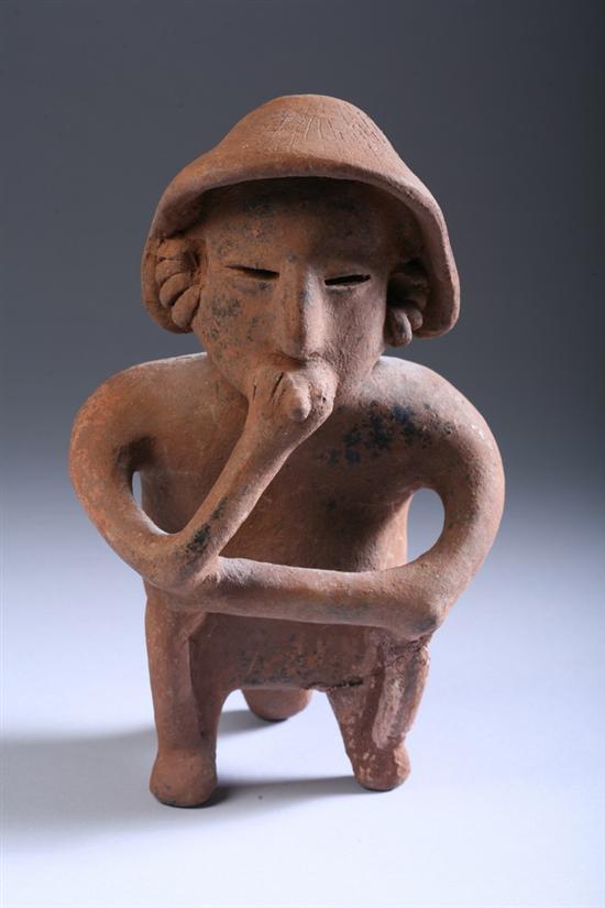 Appraisal: NAYARIT POTTERY FIGURE OF MAN Seated wearing hat and ring-form