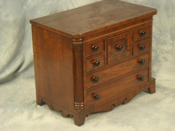 Appraisal: Miniature mahogany Regency style chest with an unusual seven drawer