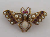 Appraisal: A late Victorian garnet ruby seed pearl and opal insect