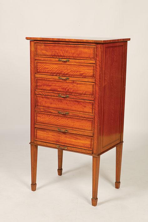 Appraisal: AN EDWARDIAN SATINWOOD MUSIC CABINET the rectangular top above six