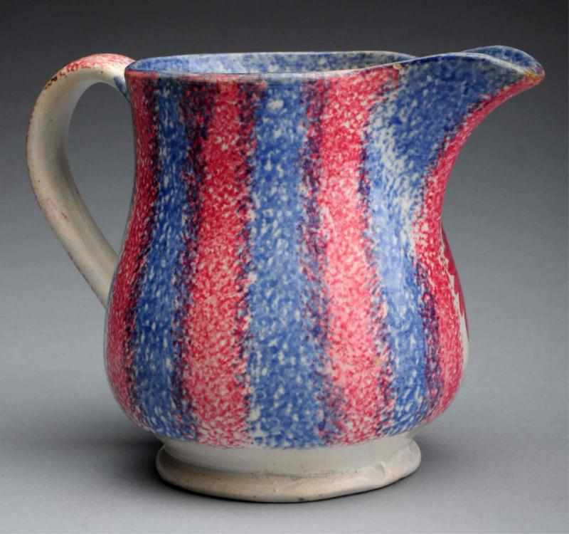 Appraisal: th Century Spatterware Creamer Unusual blue and red decoration Retains