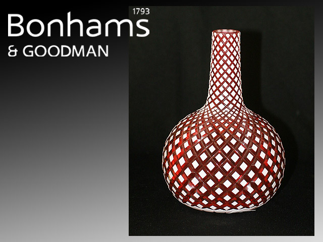 Appraisal: A diamond cut ruby glass vase with white overlay neck