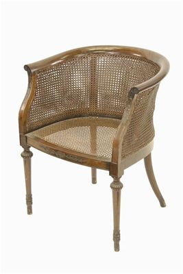 Appraisal: An Edwardian mahogany bergere armchair with caned back and seat