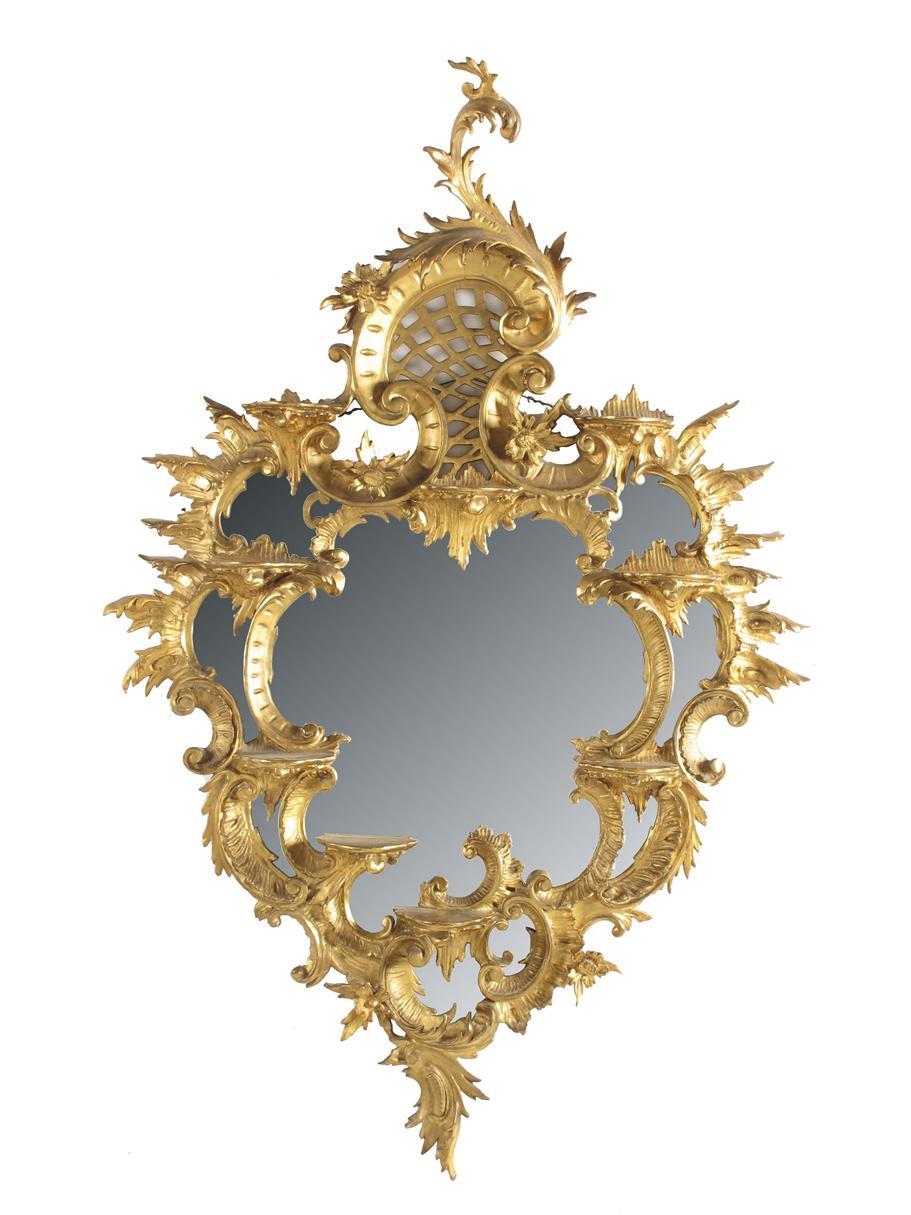 Appraisal: A carved giltwood and gesso cartouche shape mirror in Chippendale