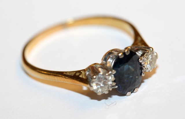 Appraisal: A THREE STONE SAPPHIRE AND DIAMOND DRESS RING oval facet