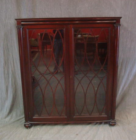 Appraisal: Mahogany Bookcase with Columns door raised on bun feet From