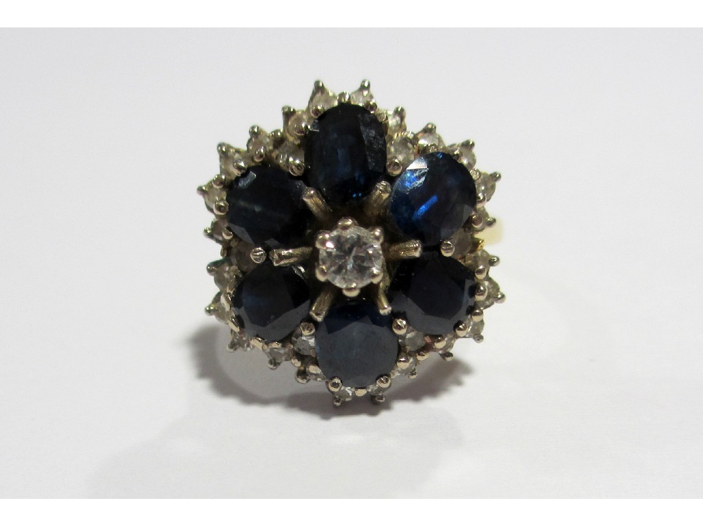 Appraisal: A sapphire and diamond circular flowerhead cluster ring with six