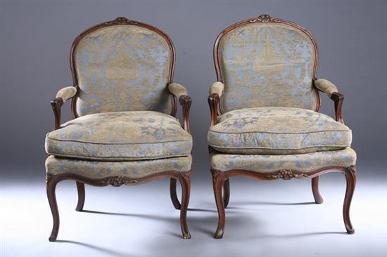 Appraisal: PAIR LOUIS XV STYLE FRUITWOOD FAUTEUILS th century Floral-crested cartouche-form