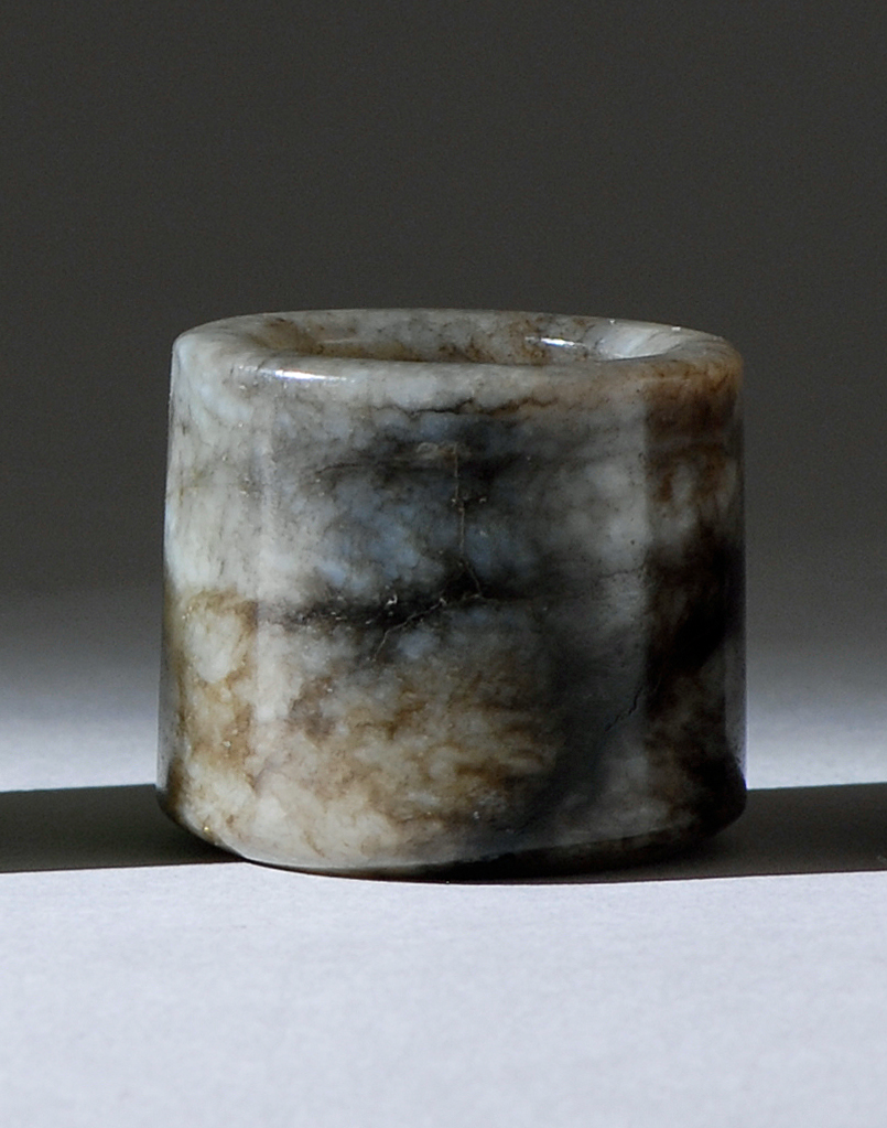 Appraisal: BLACK AND GRAY JADE ARCHER'S RING th CenturyIn cylinder form