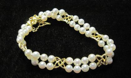 Appraisal: karat yellow gold and cultured pearl braceletDouble strand pearls accented