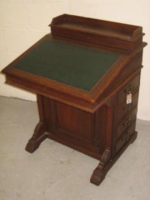 Appraisal: A VICTORIAN WALNUT DAVENPORT the raised stationery compartment with hinged