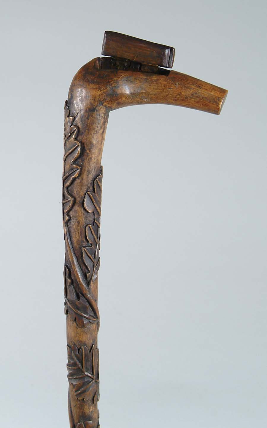 Appraisal: CANE CARVED WOOD CANE L-shaped handle has built in hinged