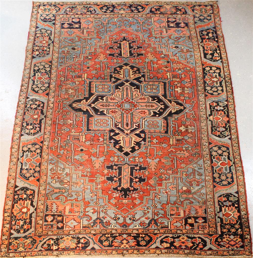 Appraisal: PERSIAN HERIZ RUG CIRCA primary colors of rust blue and