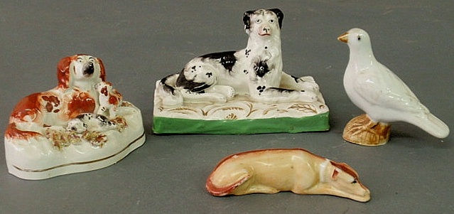 Appraisal: Four small Staffordshire figures three dogs and a dove largest