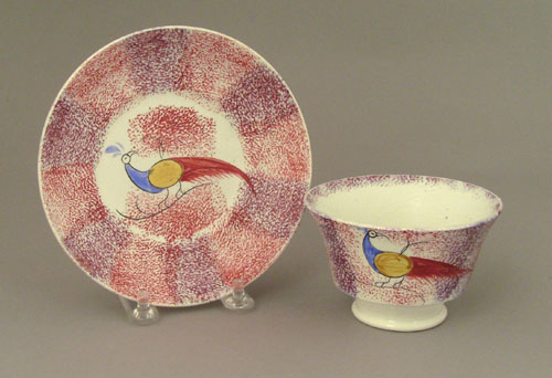 Appraisal: Red and purple spatter cup and saucer th c with