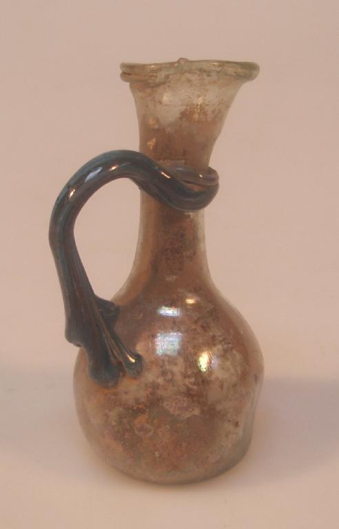 Appraisal: A small pale green Roman glass jug the irregular funnel