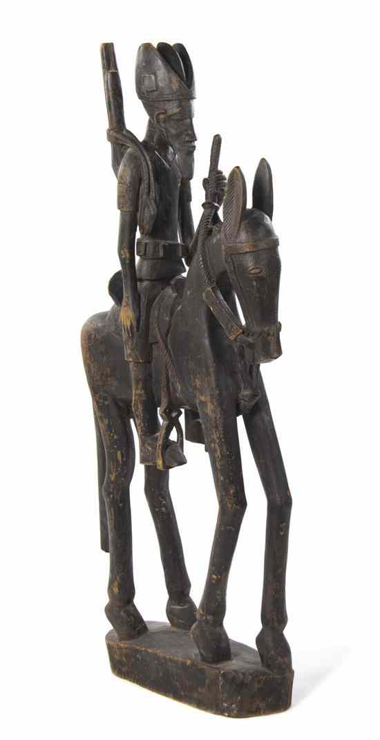 Appraisal: An African Carved Horse Rider Sculpture depicting a male figure