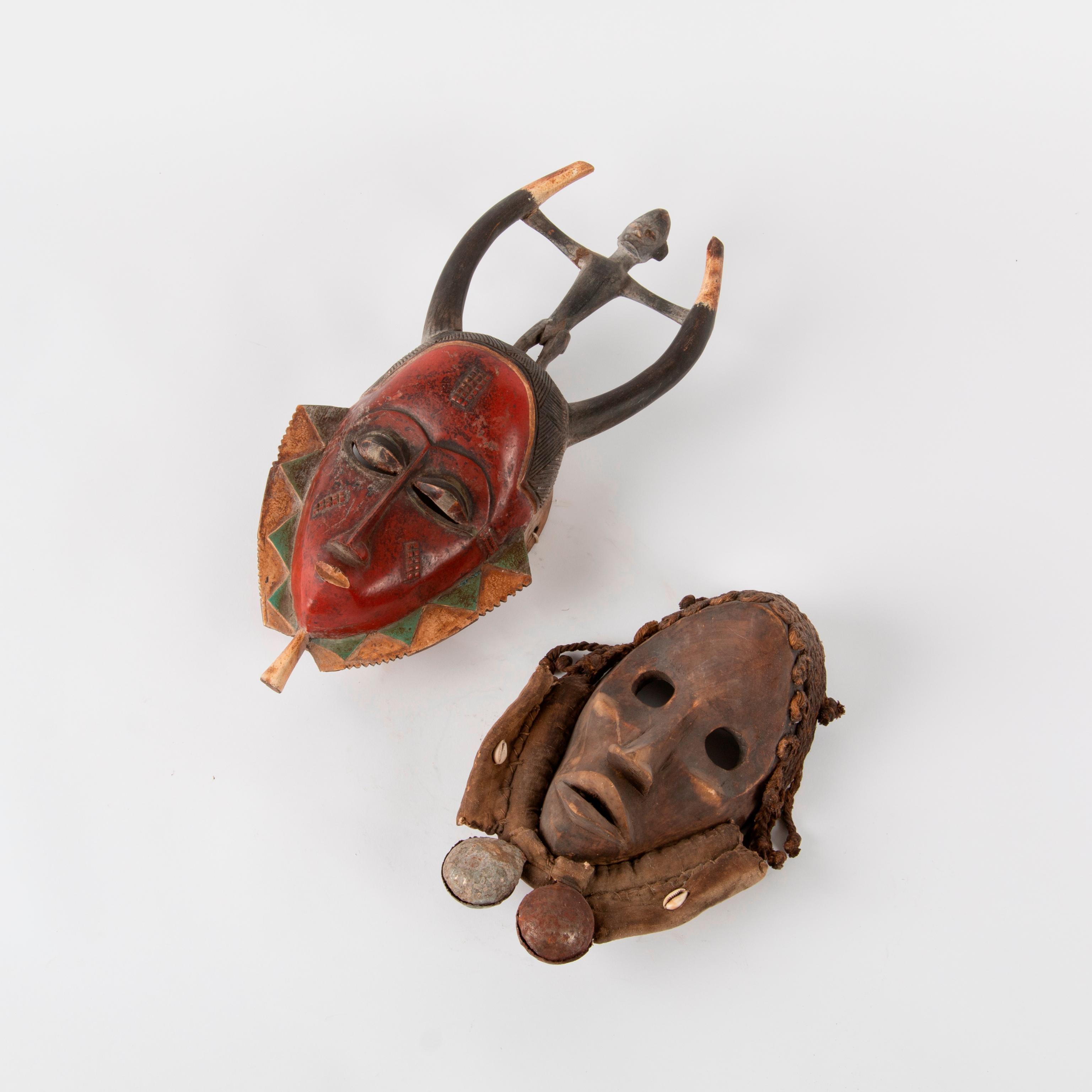 Appraisal: TWO VINTAGE WEST AFRICAN CEREMONIAL MASKS A pair of vintage