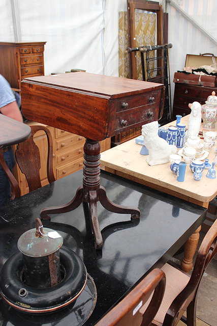 Appraisal: A VICTORIAN ROSEWOOD DROP FLAP SEWING TABLE with turned supports