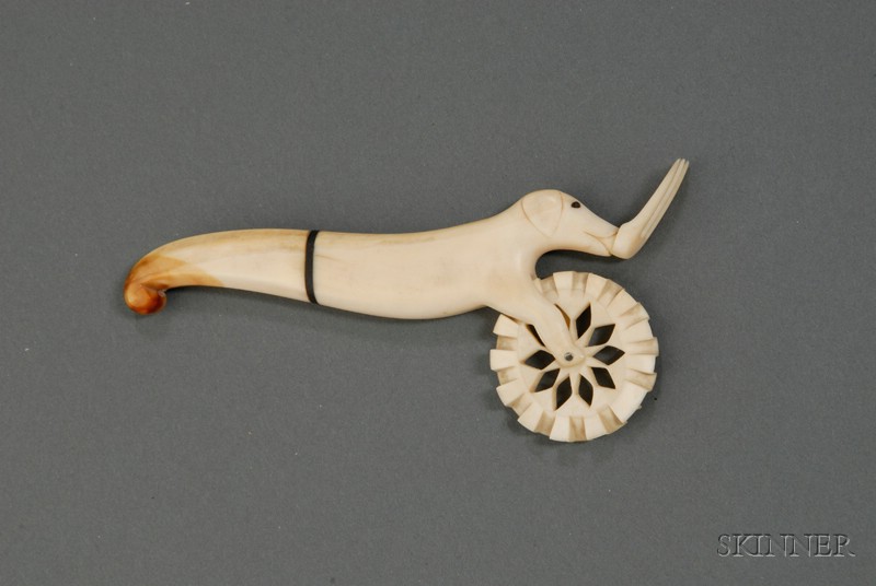 Appraisal: Carved Ivory Jagging Wheel th century the handle carved in