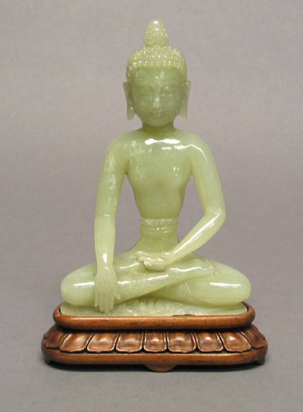 Appraisal: A Chinese carved green hardstone seated Buddha chips in high