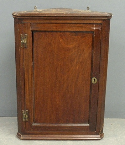 Appraisal: - Early mahogany hanging corner cabinet c with a molded