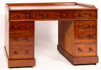 Appraisal: A mahogany pedestal desk with galleried top fitted three frieze