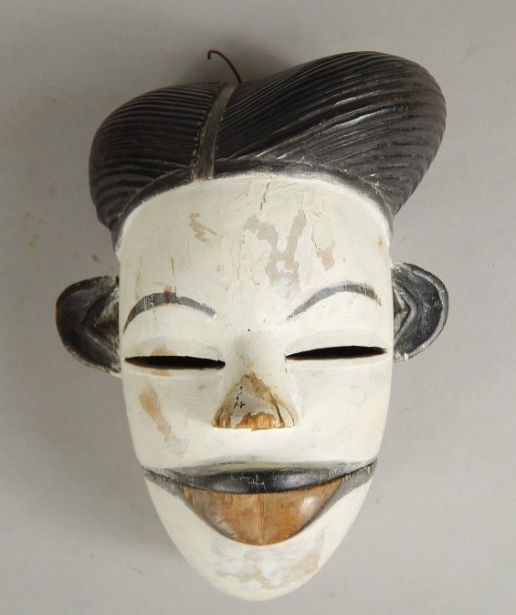 Appraisal: Tribal Art An African carved wooden mask with ebonised hair