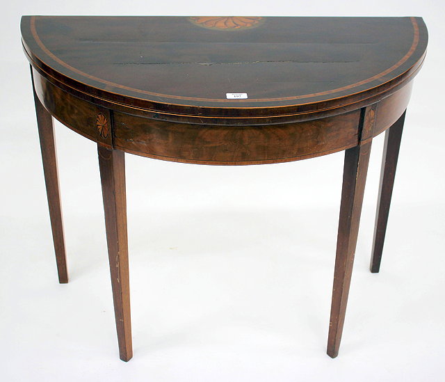 Appraisal: A GEORGIAN MAHOGANY 'D' SHAPED FOLDOVER CARD TABLE with decorative