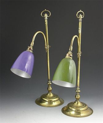 Appraisal: A pair of brass adjustable lamps with circular weighted bases