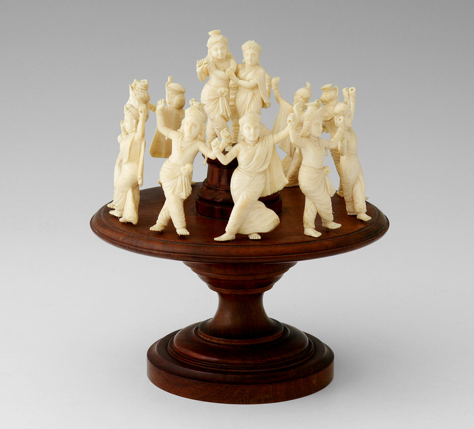 Appraisal: CARVED IVORY WEDDING DANCERS ON STAND Features wedding couple in