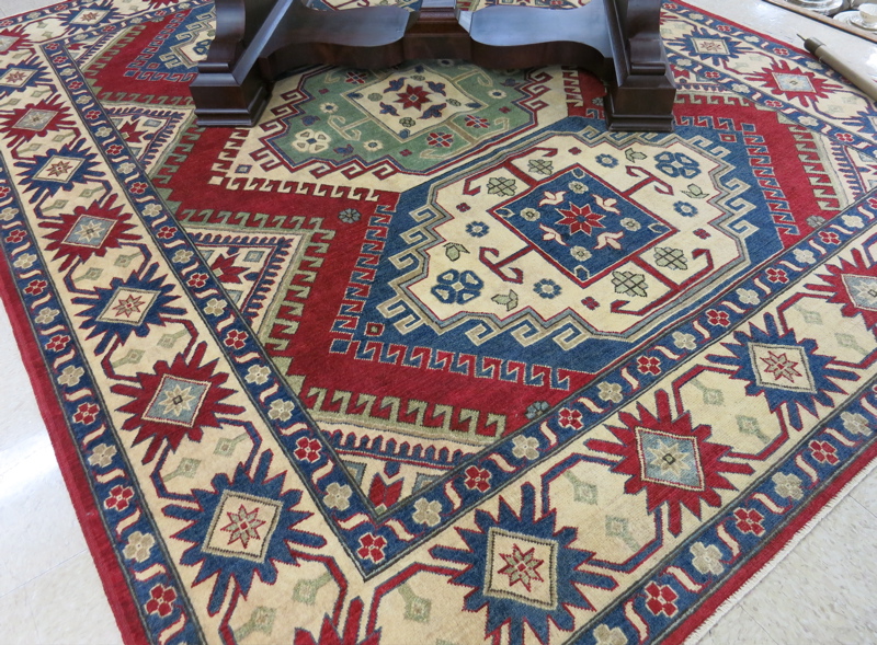 Appraisal: HAND KNOTTED ORIENTAL CARPET Pakistani-Caucasian Kazak three geometric medallion design