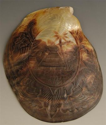 Appraisal: A Samoa carved abalone shell decorated with huts amongst palm