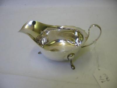 Appraisal: A SAUCE BOAT of shallow oval formed with gimped rim