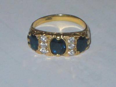 Appraisal: A SAPPHIRE AND DIAMOND RING comprising three oval sapphires set