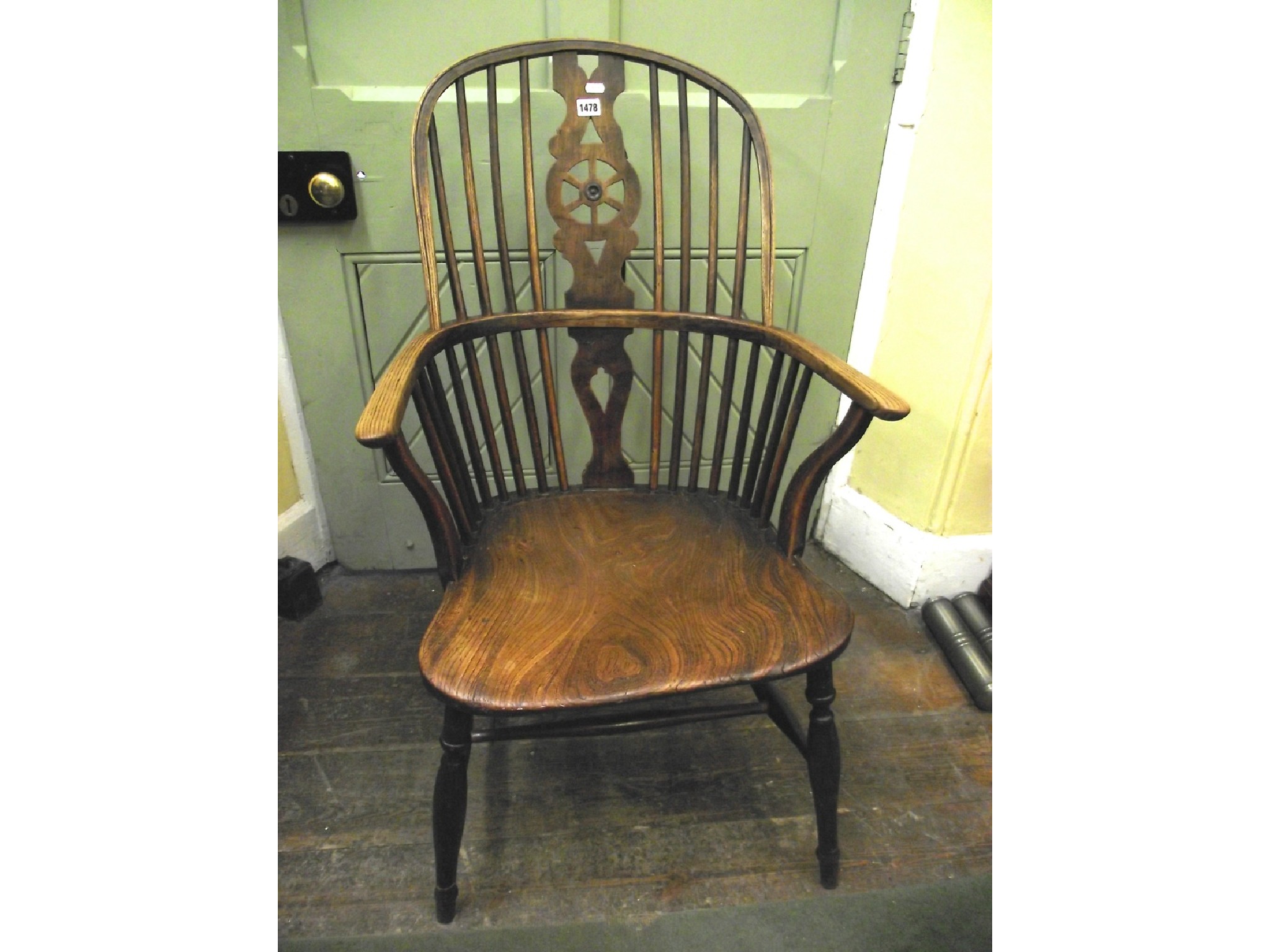 Appraisal: A Georgian comb back elbow chair with pierced wheelback splat