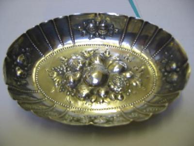 Appraisal: A GERMAN WHITE METAL BONBON DISH stamped Handgetrieben of oval