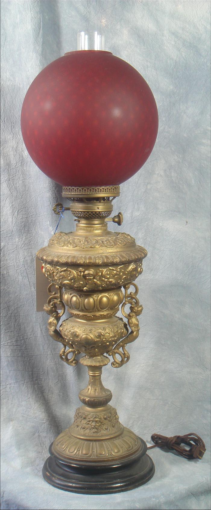 Appraisal: Victorian style banquet lamp frosted ruby round shade h Estimate