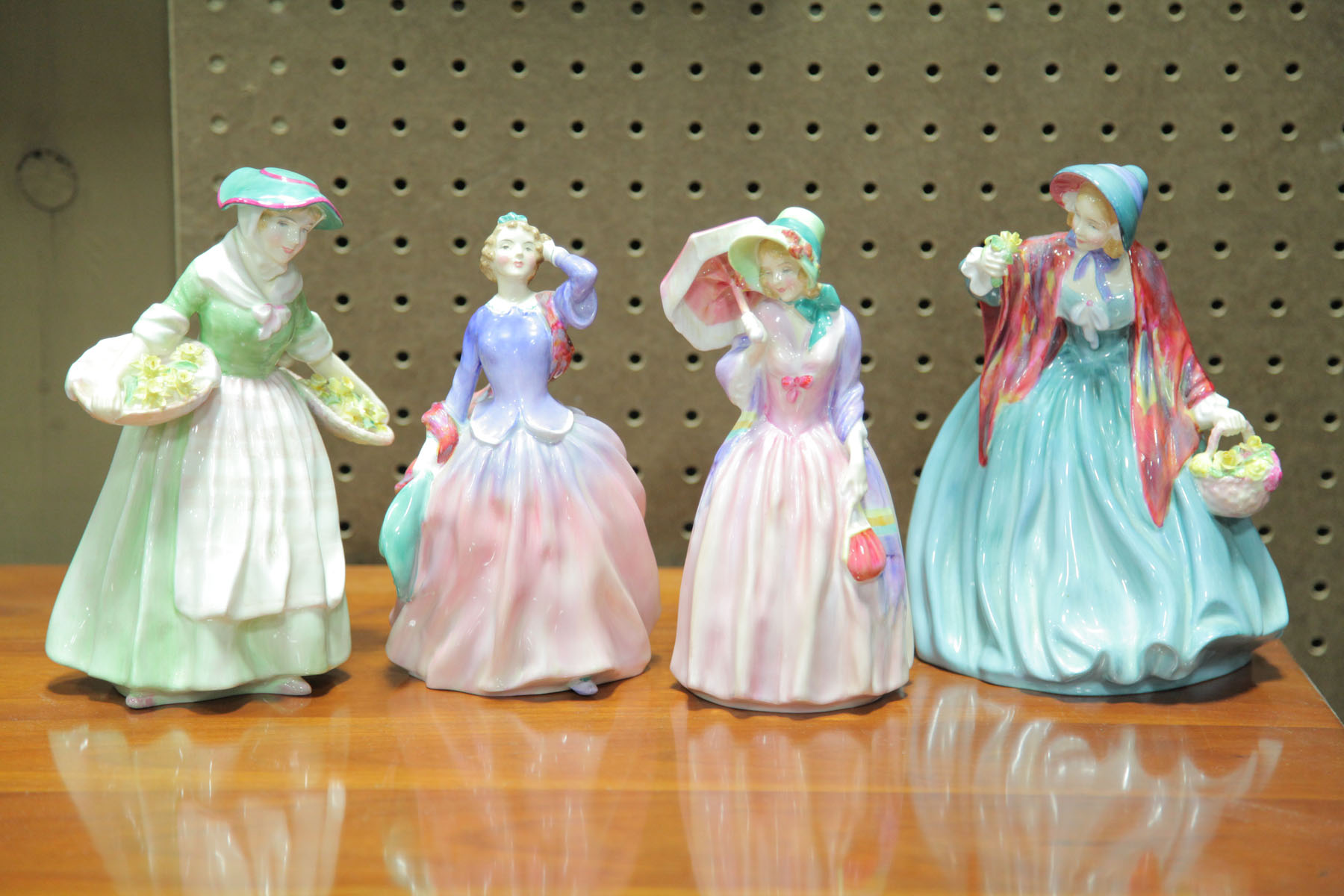 Appraisal: FOUR ROYAL DOULTON FIGURES English th century Daffy Down Dilly