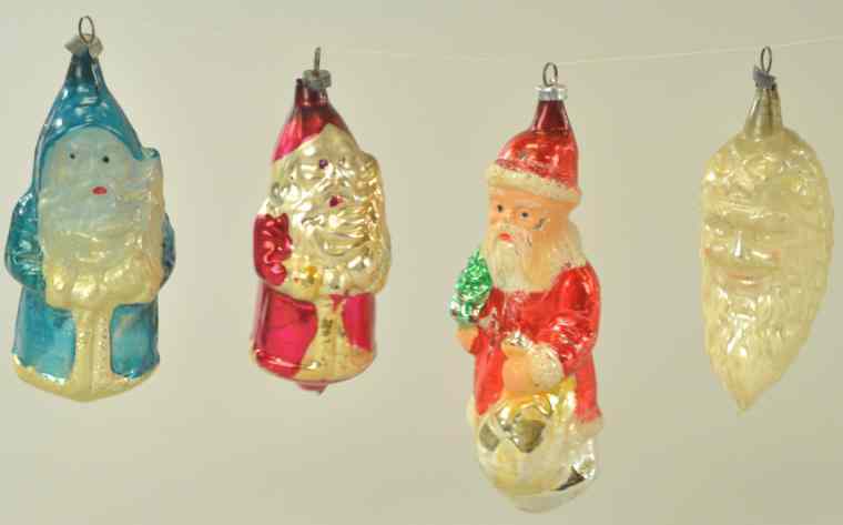 Appraisal: FOUR SANTA CHRISTMAS ORNAMENTS Germany blown glass Father Christmas w