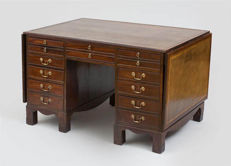 Appraisal: GEORGE III MAHOGANY PARTNER'S KNEEHOLE DESK Fitted with leather-lined leaves