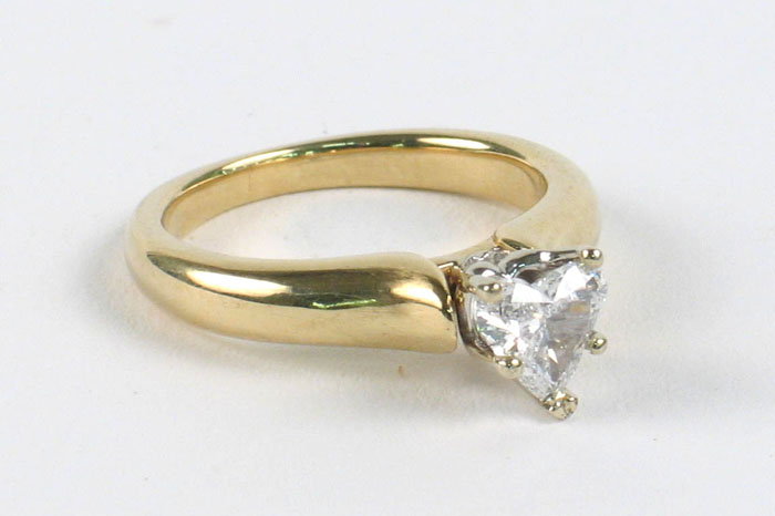 Appraisal: LADY'S DIAMOND SOLITAIRE AND FOURTEEN KARAT GOLD RING centering a