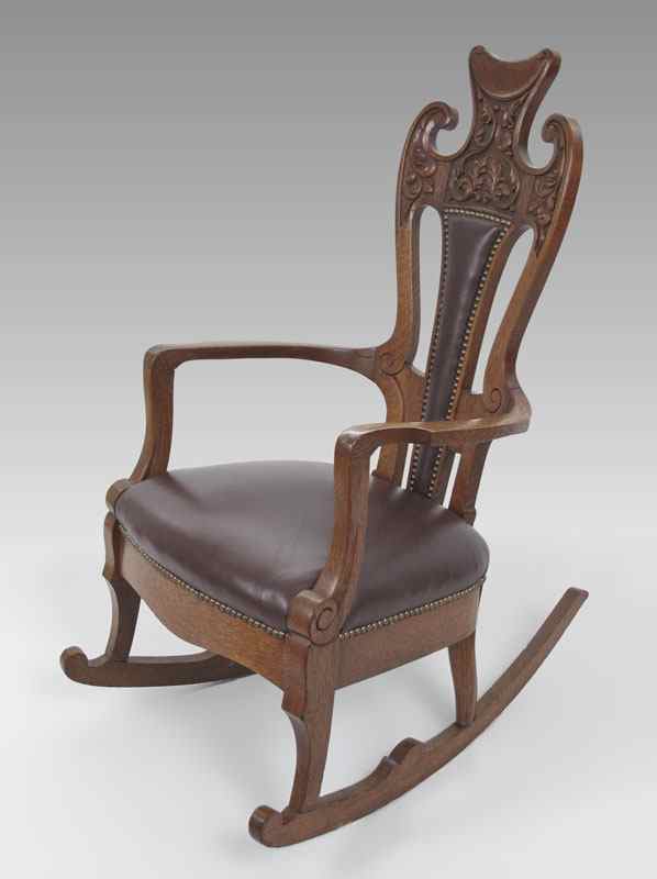 Appraisal: LATE VICTORIAN GOLDEN OAK CARVED ROCKER Richly carved crest newer