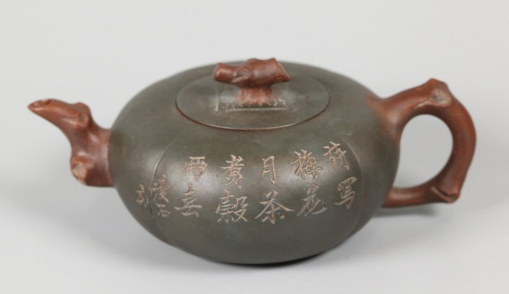 Appraisal: Chinese yixing teapot one side decorated with flowers emerging from