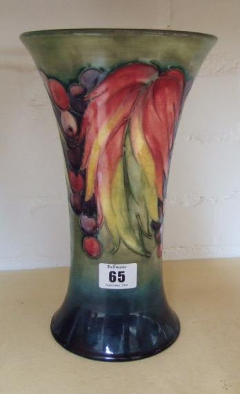 Appraisal: A Moorcroft 'Leaves and Berries' vase of trumpet form impressed