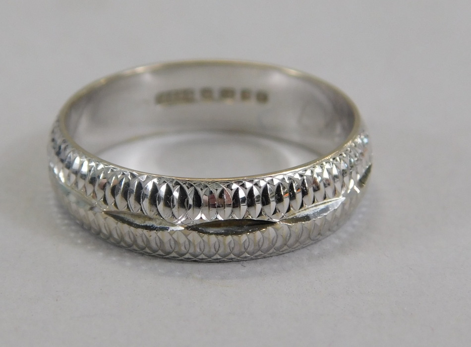 Appraisal: An ct white gold wedding band with engraved design g