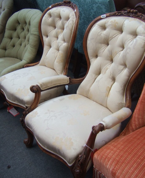 Appraisal: A Victorian walnut spoon back armchair with floral carved crest