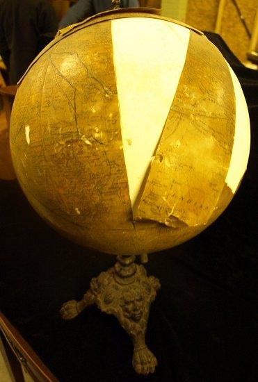 Appraisal: A terrestrial globe on a cast iron stand with tripod