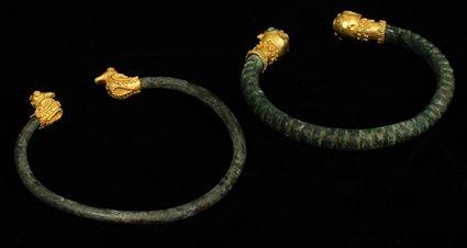 Appraisal: TWO BRONZE LURISTAN BRACELETS WITH MODERN GOLD TERMINALS and in